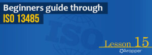 Blue header banner for "Beginners guide through ISO 13485" Lesson 15, featuring the qmsWrapper logo and a globe graphic representing global medical device standards.
