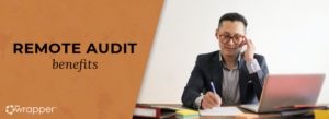 A professional auditor in glasses working at a laptop and taking notes, representing the benefits of remote auditing such as increased efficiency and cost flexibility.